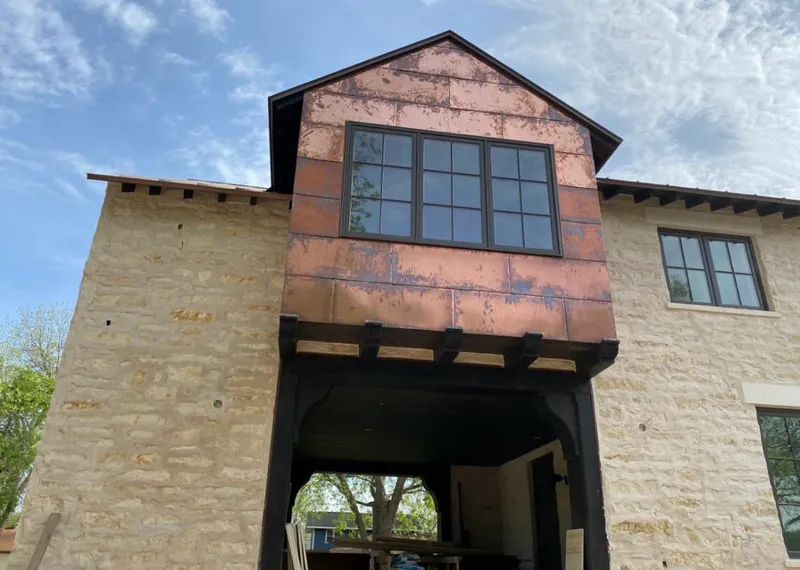 Copper metal panel facade on a stone building for Skylight Installation in Fair Oaks Ranch